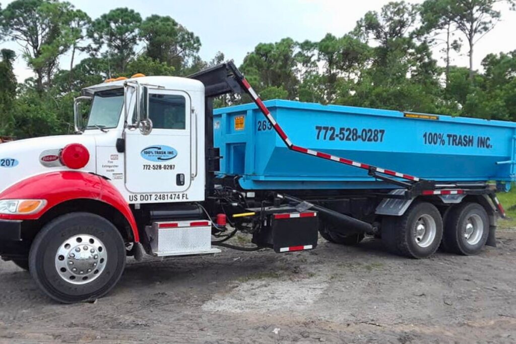 Blue waste truck with contact information.
