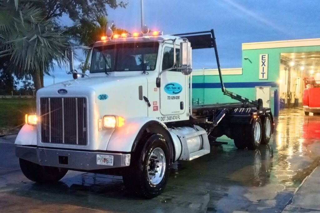 White truck parked outside garage at dusk