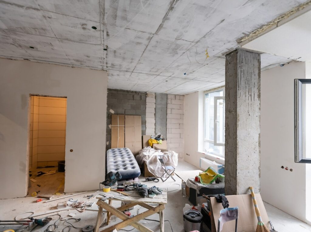 Room under renovation with tools and materials.