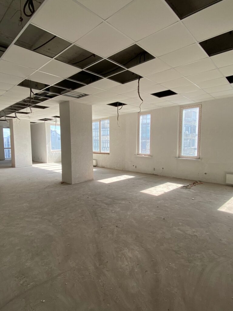 Empty office space with broken ceiling tiles