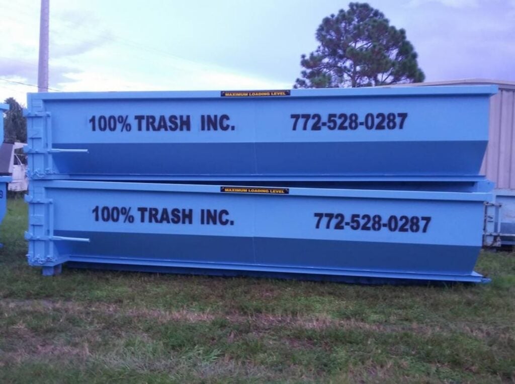 Blue dumpsters with company name and contact number.
