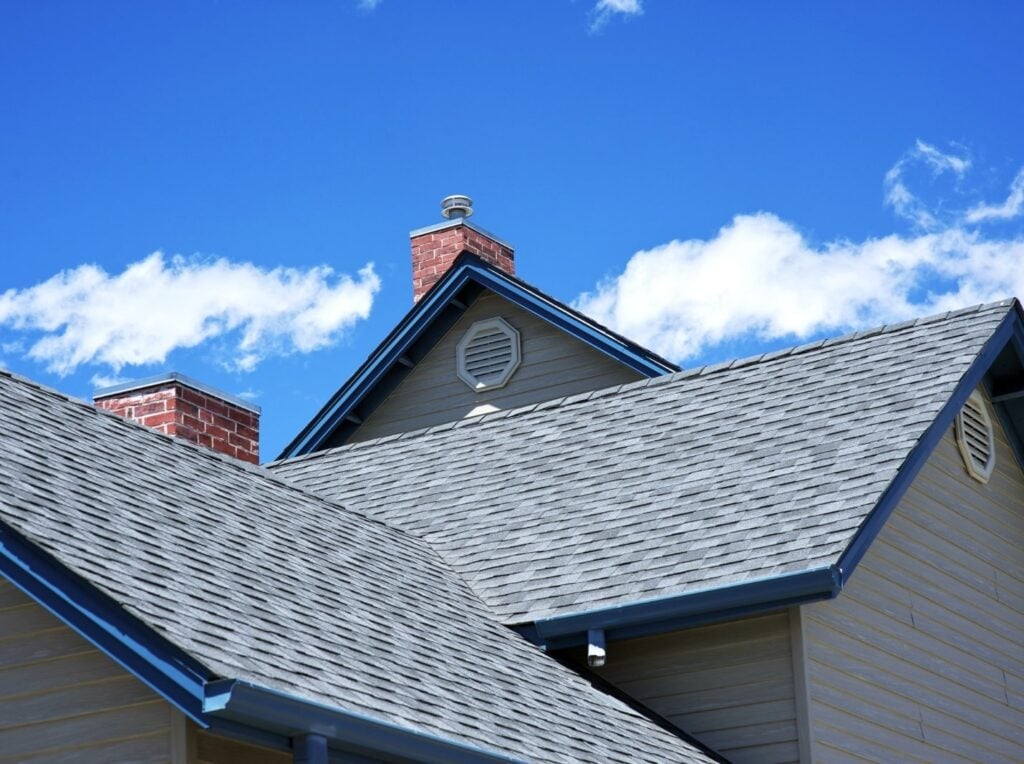 House roof with blue sky and clouds